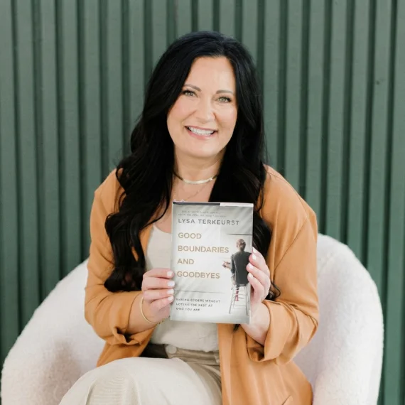 An author holding her published book