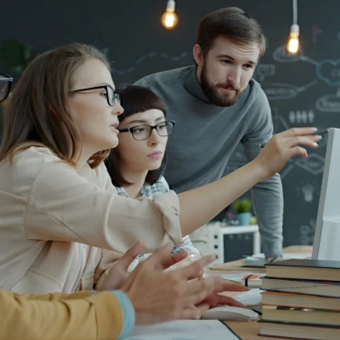 A team reviewing book listing performance on screen