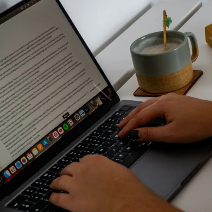 An author working on their manuscript at a laptop