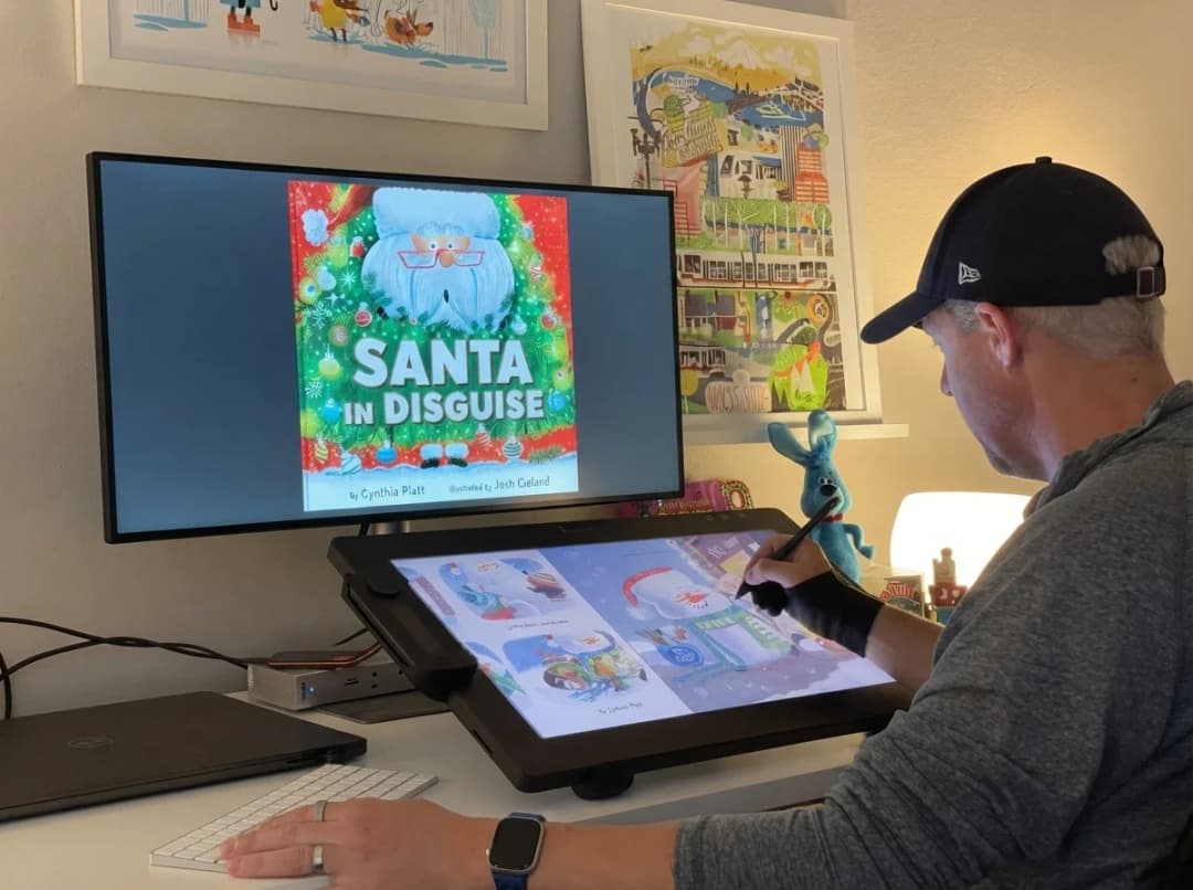 An illustrator drawing a children's book cover on a pen display